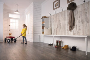 Gray wood-look flooring in a bright mudroom entryway